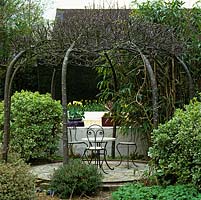 Arbour made from eight hornbeams bent inwards and entwined.