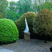 'Moon Bird' by Bridget McCrum rests on a gravel terrace enclosed in yew hedge, between box ball and Italian buckthorn bush.