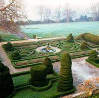 Planted in 1901, formal parterre of box hedges infilled with lavender, grass or gravel and giant yew topiary shapes - cones, spirals, pyramids, domes and birds.