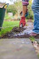 Remove soil to add depth and hollow out the new path. 