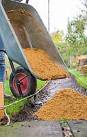 Fill the new path with an equal distribution of a coarse grit sand. This will need to be a 2 inch layer of sand. 