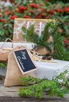 Christmas present wrapped in Hessian, accompanied with Yew foliage