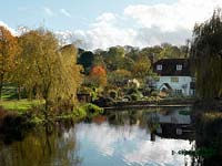 A mill house and garden beside the river Test.