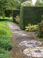 Path created from old circular mill stones and bricks.