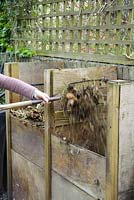 Turning garden compost from one heap to another