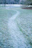 Mown path through rough grass in winter. Trinity College, Cambridge