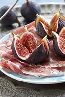 Ficus carica - fresh figs on plate with ham