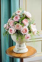Rosa 'Keira' in a cut flower arrangement on a table indoors
