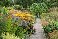 Lanhydrock Garden, otherwise known as the hot garden, planted with heleniums, dahlias, Ligularia dentata 'Desdemona', Erysimum 'Apricot Twist', agapanthus and golden Hakonechloa macra 'Aureola'. Wollerton Old Hall, nr Market Drayton, Shropshire, UK