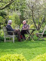 Crawford and Rosemary Lindsay sit under an old apple tree in their 45m x 12m town garden.