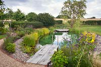 View of wooden decking leading to Swimming Pond. 