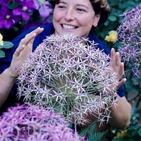 Katie Moray pictured behind a huge Allium cristophii.