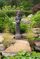 Indonesian goddess statue in the Zen garden at the Route des Gerbes d'Angelica garden, Mirabel, Quebec, Laurentians, Canada