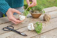 Gently place the Egg shell within the hanging satchel. 