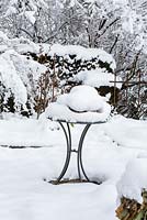 Bistro table covered with snow