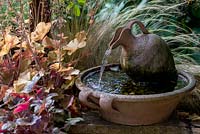 A small water feature made from terracotta.