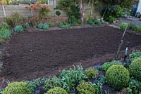 Lawn Restoration. After removing the top 3 - 4cm of the old lawn, the soil is dug to a depth of 15cm.