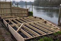 After removal of rotten timbers and build-up of mud under planks, a new base is constructed above a weedproof membrane.