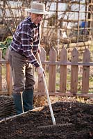 Early spring preparation of vegetable beds. Raking.