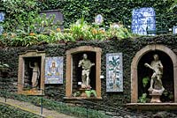 Tiled panels, niches filled with classical statuary, carved into the walls at Monte Palace Tropical Garden, Madeira