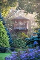 Tree house on a misty morning at Foggy Bottom, The Bressingham Gardens.