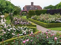 Shrub Rose Garden. Rosa Erfurt, Mary Rose, Jacques Cartier, Brother Cadfael, Miss Alice, Cottage Rose, Comte de Chambord, St Swithun. Arch: Mdme Isaac Pereire.