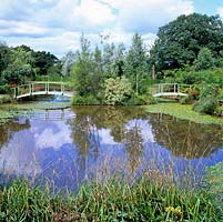 Inspired by Monets bridge, Chris Bissell, an engineer, created these bridges spanning a spring-fed, 4m deep lake planted with native water lilies.