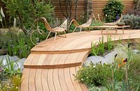 Royal Bank of Canada Garden - laminated wood hammock style benches and a table on red cedar wood decking, cedar garden wall 
