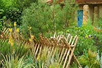 Wooden hurdle fence made of peeled chestnut poles, Sentebale - Hope in Vulnerability garden. RHS Chelsea Flower Show 2015