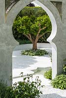 View of a citrus tree in a tranquil courtyard. The Beauty of Islam  Garden. RHS Chelsea Flower Show, 2015