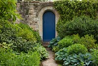 Doorway in a stone wall at Kiftsgate Court Gardens, Chipping Campden, Gloucestershire, UK
