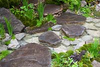 Edo no Niwa - Edo Garden. Stream and stepping stones in a Japanese garden. RHS Chelsea Flower Show 2015. 