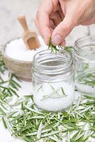 In glass jars create layers of sea salt then rosemary until the jar is full