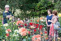 Nursery owner Nick Gilbert with visitors in the dahlia field