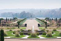 View across the Italian Garden towards the mile long Capability Brown lake. Includes fastigiate Irish yews, fountains, clipped Portuguese laurels, herbaceous perennials and grasses. Trentham Gardens