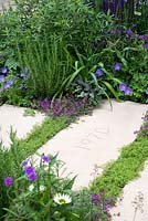 Gaps in paving filled with Chamaemelum nobile - The Wellbeing of Woman Garden, RHS Hampton Court Palace Flower Show 2015 - Design: Wendy von Buren, Claire Moreno, Amy Robertson