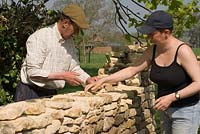 Father and daughter - John and Lou Shone building up a dry stone wall
