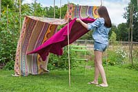Lay down a colourful rug to rest on underneath your canopy