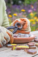 Using tile nippers to cut mosaic pieces into required shape