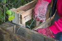 Use metal wire to secure the wooden pallets together