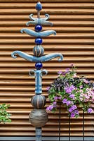 Decorative pole made of various ceramic elements, Petunia Surfinia, Verbena, Ipomea batata