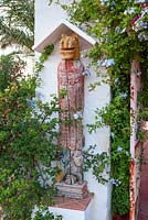 Gate post with wooden sculpture - Entrance to patio area. 