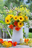 Jug of herb and edible flowers - marigold, fennel, borago, mint, nasturtium