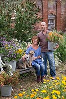 Patrick Cadman and Sheree King with their dogs in the cutting garden