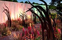 Best Conceptual Garden - Desolation to Regeneration. RHS Hampton Court Palace Flower Show 2013. Gold Medal. Corten steel sculptures resemble burned trees. Design: Catherine MacDonald 