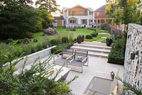 Wide overview of the garden featuring the path, pergola, gabion feature and sunken seating area