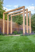 The pergola feature in the middle of the pathway, underplanted with Lavandula angustifolia 'Hidcote' and borders of Verbena bonariensis and Delphinium elatum 'Blaustrahl'