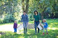 Martine van Harten one of the founders of CO BOMEN, Foundation for the preservation of old orchards. Harvesting with Remco and Luc and friend.