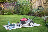 Tools required for performing a full maintenance on your lawnmower. Wax coated sheet, multi purpose oil, lawnmower oil, tray, brush, trowel, sharpening stone, socket and spanner set , spark plugs, air filter and a nut wrench