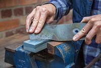 Sharpen your lawn mower blade on the lubricated sharpening stone